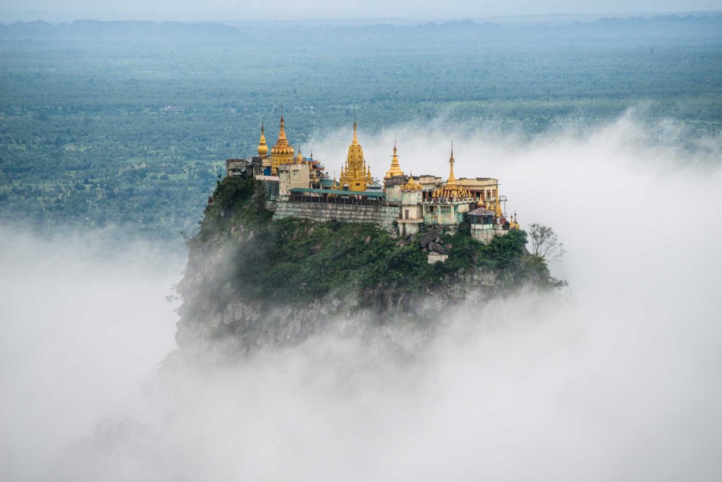 Discover mystery and beauty in Myanmar. Destinations Worth Dreaming Image: A beautiful structure sits atop a mountain shrouded in mist.