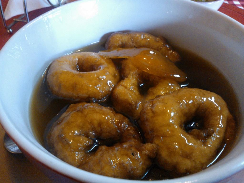 ...like warm little life preservers swimming in a sweet brown sea of raw sugar syrup. Visit Peru Image: Delicious fried sweet potato dough swims in a sweet brown broth of raw sugar syrup.