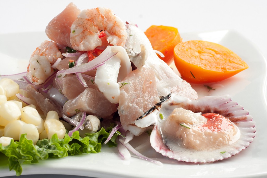 This interesting dish relies upon the acidity of citrus fruits to cook fish. Visit Peru Image: A close-up of beautifully arranged ceviche on a white plate is the perfect start to a Peru food tour.