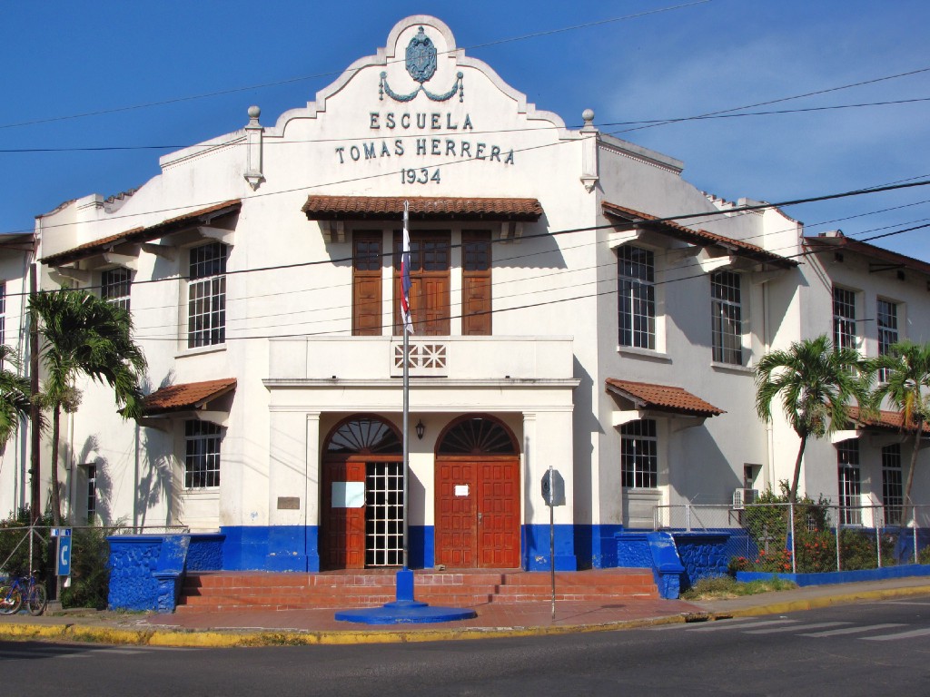 The mix of building structures and colours in Panama is quite interesting. Architecture In Panama Image: Escuela Tomas Herrera is a Spanish Colonial building with red doors, and blue accents near the base of the building