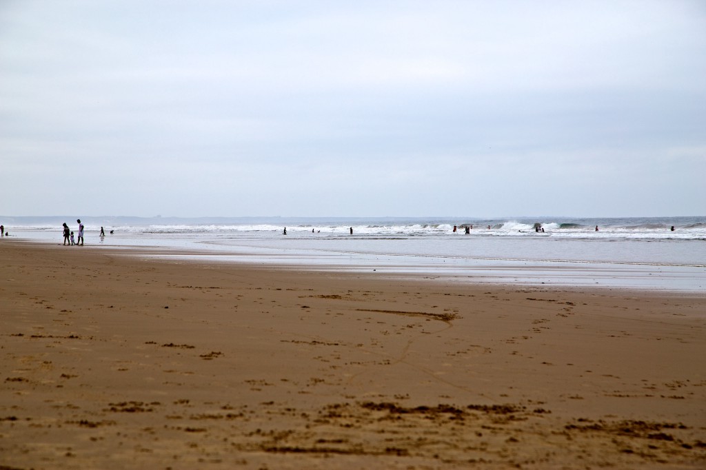 The great thing about this city is that you can enjoy a generous stretch of beach even when you're not in the water. Best Surfing Beaches: People are enjoying the sand and surf of a long and wide stretch of beach.