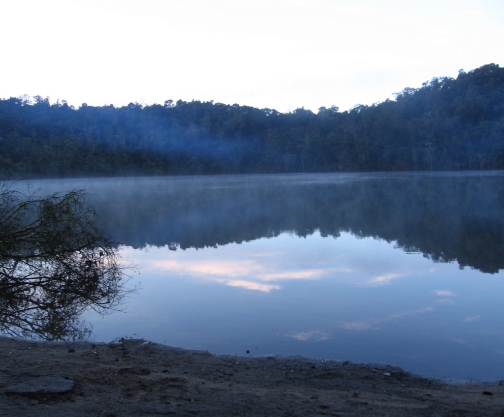 Nature reflected in one of nature's very own features—if you pause, it really makes you think. Mystical Destinations Image: The surrounding trees and sky are visible and reflected in the waters of the lagoon.