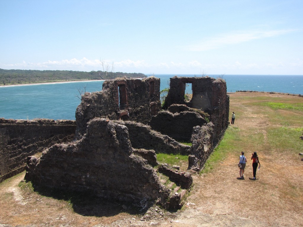 And yet, there's something charming about the way they overlook the sea. Architecture In Panama Image: Three travellers are near the San Lorenzo Fort. The section we're looking at is in ruins, and overlooks the sea.
