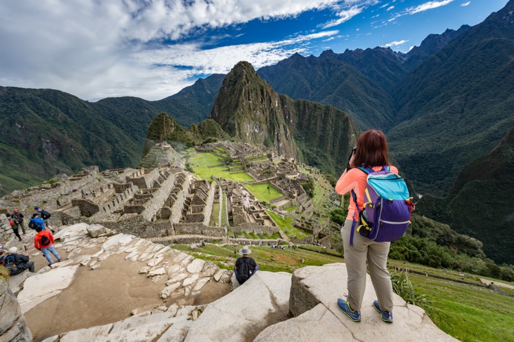 Don't you agree that this is far more unique than sending a postcard from Hawaii? (No offense, Hawaii!) Central and South American Ruins Image: Travellers are staggered on different levels of a ruin at Machu Picchu. At the top most level, a woman wearing a backpack is poised to take a photograph.