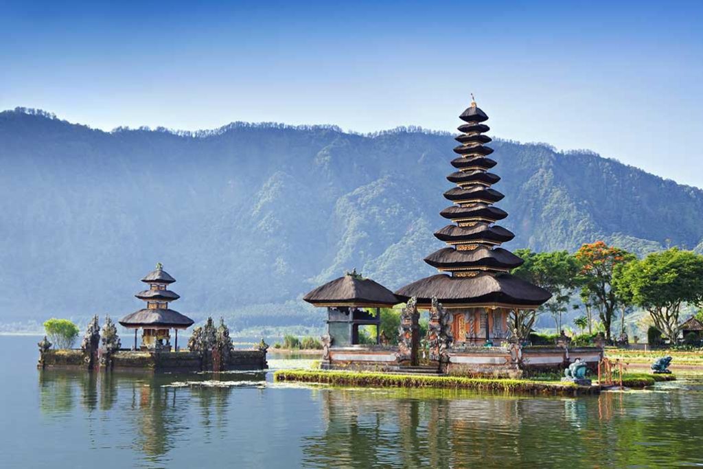See all of the world, not just some of it. Destinations Worth Dreaming Image: A beautiful pagoda has 11 tiers which from a graceful point. To the immediate left is smaller structure. Further left is a three-tiered pagoda. This scene overlooks water and has a green mountain range in the background.