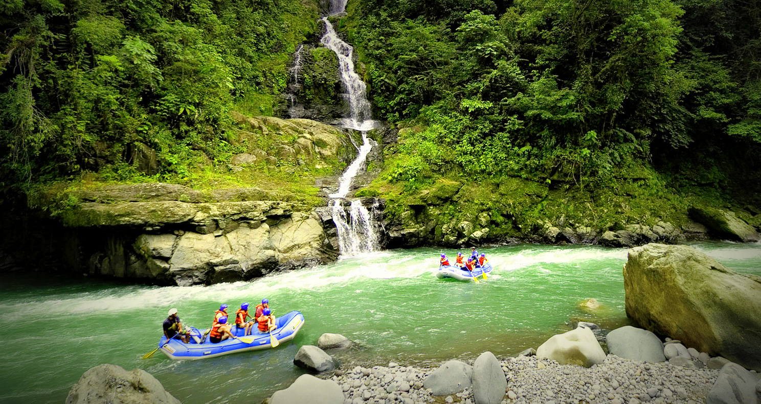A waterfall and rapids? What a treat! Costa Rica Rafting Image: Pacuare River. Two rafting boats full of adventurers are making their way down the Pacuare River.