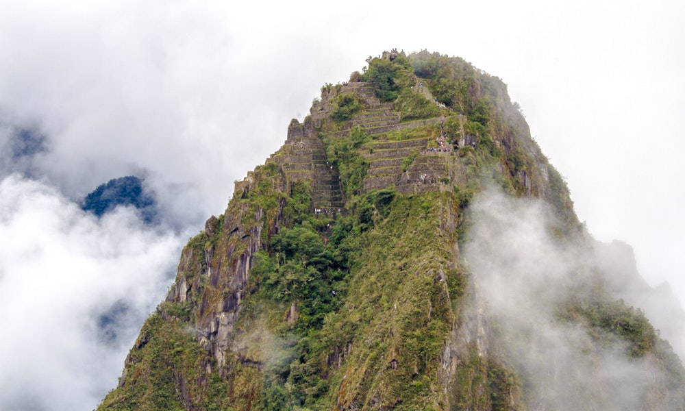 If you think this photo is incredible, imagine the view from up there. Machu Picchu Travel Image: Machu Picchu emerges through the clouds of Peru.