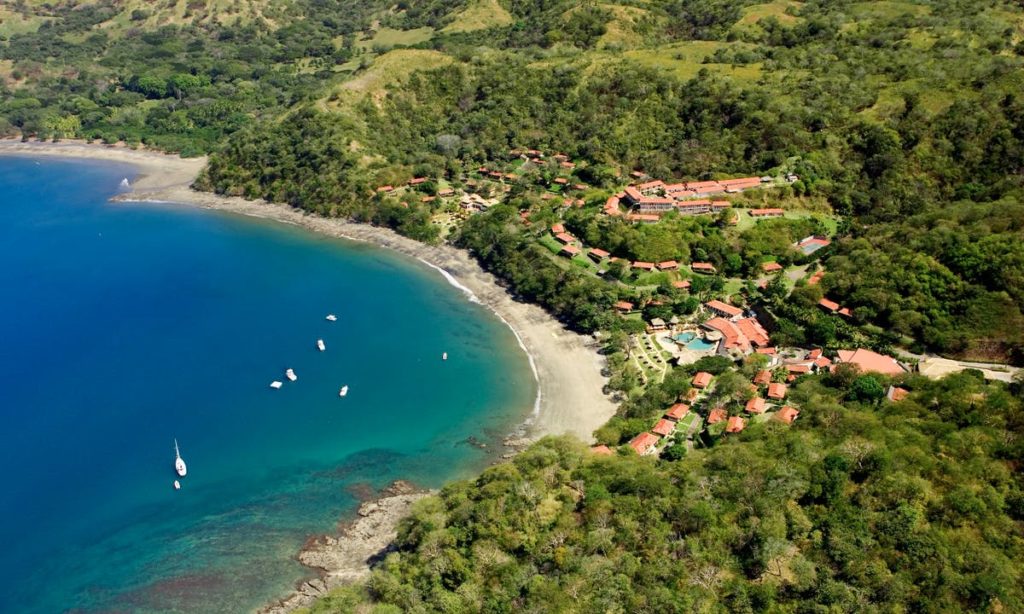 Wouldn't be surprised if these watercraft are sailing away on a sea of bliss. Best Beaches Image: Costa Rica. A small handful of watercraft sail about a pristine blue inlet. Save for the accommodations built into the land, the area is green.