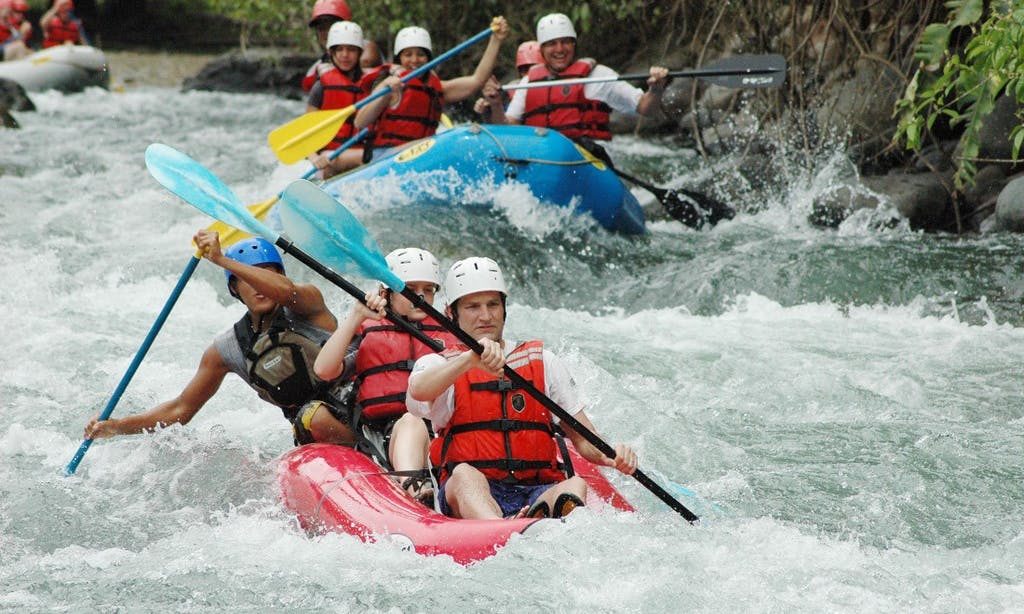 Prepare to splash, paddle, and smile as you navigate the waters. Costa Rica Rafting Image: Savegre River. Three rafts hold groups of people splashing, paddling, and smiling as they navigate the waters.
