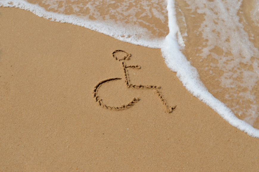 Don't let accessibility needs stop you from going on a family holiday. Accessible Travel Image: The accessibility travel of a wheelchair is drawn in the sand as waves flow in. Don't let accessibility needs stop you from going on a family holiday.