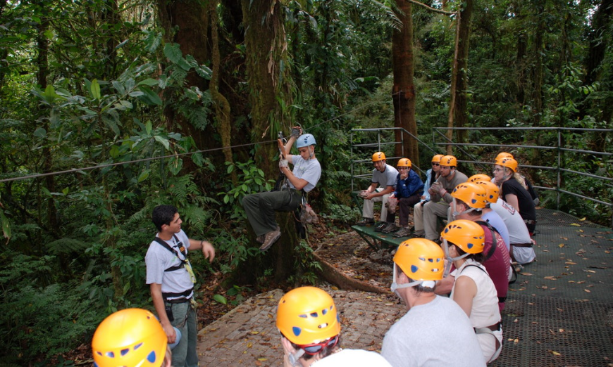 They're about to zoom into adventure, and you can too. Costa Rica Adventure Trips Image: Zip liners sit, and patiently observe and listen to instructors.