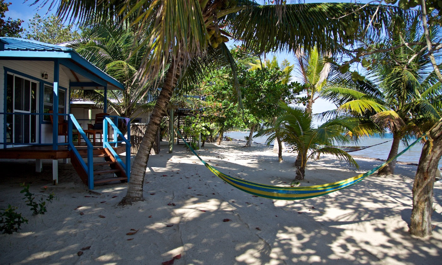 Talk about convenience—after a rest break, you're steps away from taking another swim. Best Beaches for Swimming in Belize Image: A colorful hammock hangs outside of a beach bungalow.