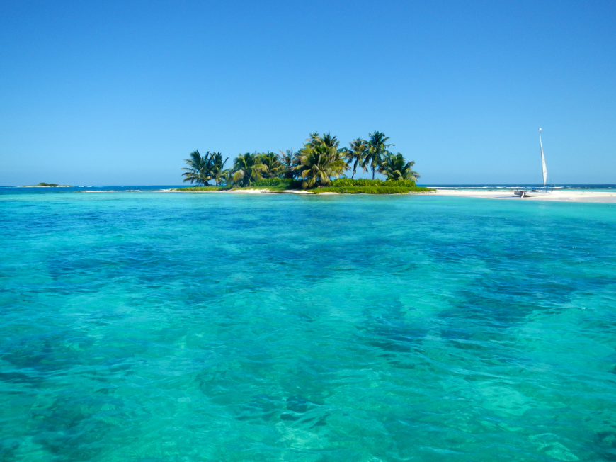 Sublime serenity is waiting for you on this tropical isle. Best time to visit Central America Image: Beautiful turquoise colored water near an idyllic island barrier reef in Belize.