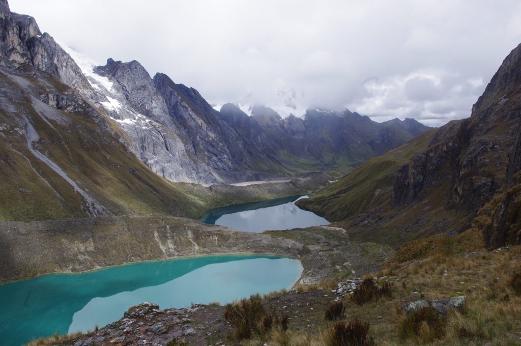 Peru is beautiful, but mind the potential of experiencing altitude sickness. Best Time To Visit South America Image: Mountains, clouds, and recessed lakes making for a scenic view in South America's Cordillera Huayhuash.