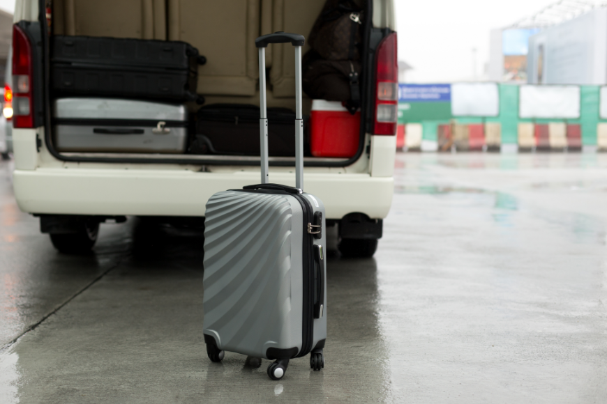 You won't get poached by taxi scammers if you follow Anywhere's expert advice! Booking A Vacation Online Image: A silver suitcase sits outside of the trunk of a white van already loaded with other suitcases.