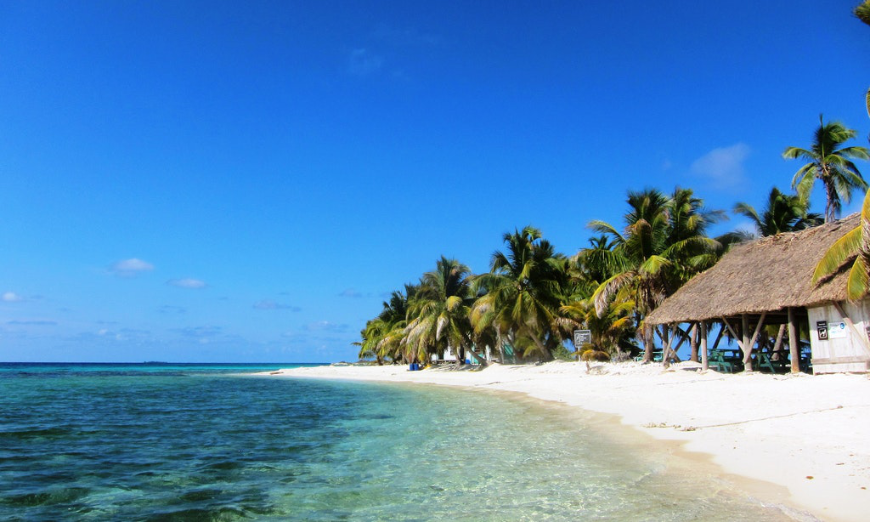Not being able to stay on the island won't diminish the experience of visiting it. Central America Islands Image: Crystal waters lap a white sand shore lined with palm trees and beach stations.