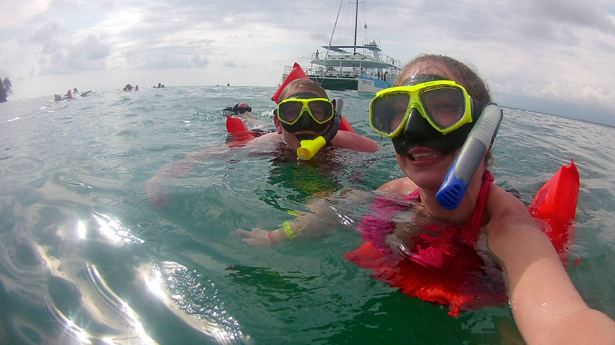 There's so much to explore on land and in the seas of Costa Rica. Costa Rica Mother's Day Image: The author's daughter and granddaughter take a picture in the water wearing red swimming vests, and neon yellow snorkels.