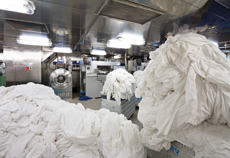 Did you know?: Bed and bath linens are good for multiple uses?! Eco-Friendly Destination Wedding Image: Oversized loads of laundry wait in a hotel's laundry facilities.