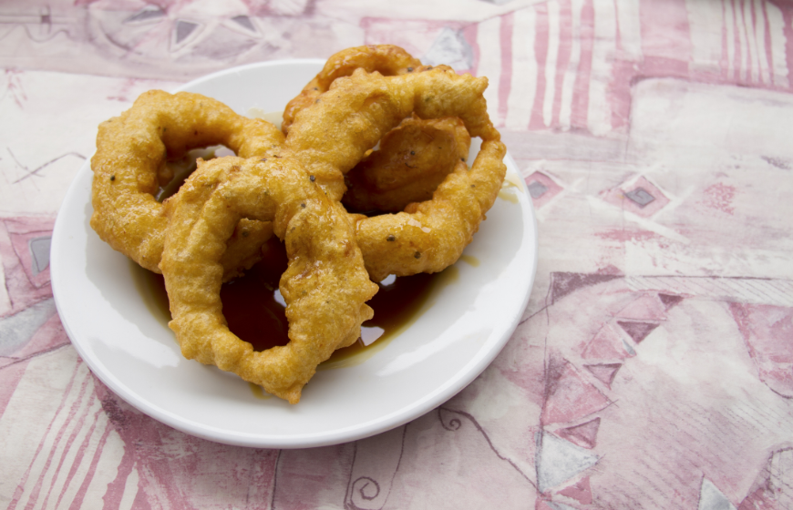 Discovering sweet treats is a wonderful part of sampling foreign cuisine. Eat In Peru Image: Picarones donuts with dipping syrup.