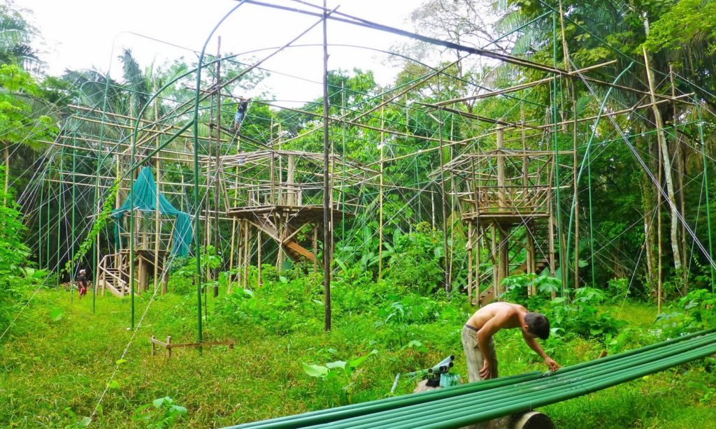 When possible, always build green as well. Eco-Friendly Costa Rica Image: A volunteer is working on green pipes. Behind him are the beginnings of structures made of this green pipe, and what one would assume is local wood.