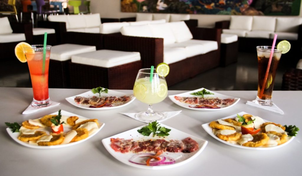 Now THIS is how you should make your voyage to the Galápagos Archipelago. Galápagos Islands Image: A shot of the EcoGal VIP reception area shows well designed seating, and a variety of snacks and beverages on a white tablecloth.