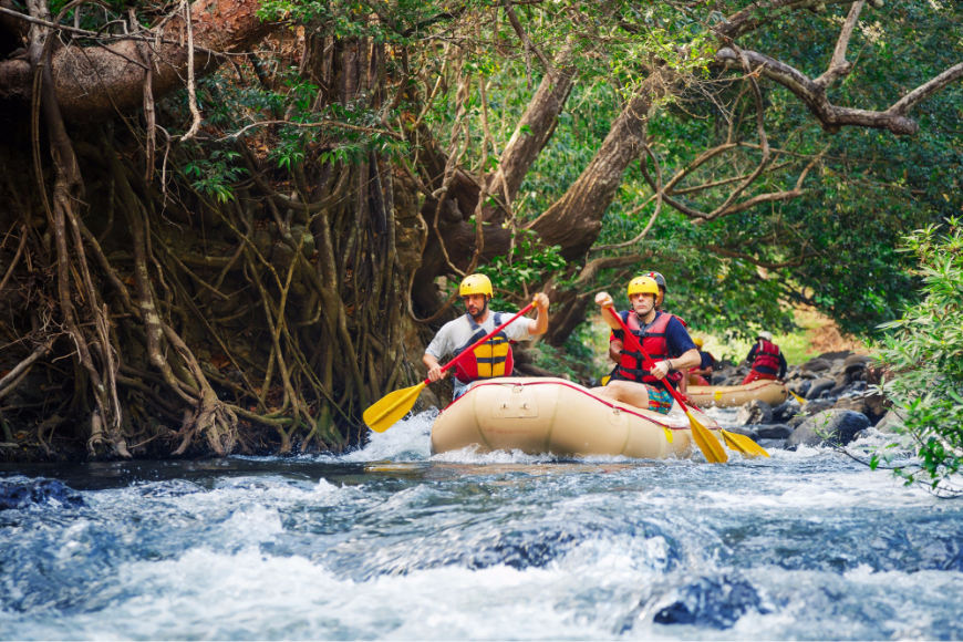 Rain doesn't matter when you're already wet... Green Season Image: Travelers enjoy a whitewater rafting adventure on a jungle's river.