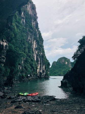As if kayaking isn't enough of an adventure... Caving in Vietnam: Two kayaks are on the shore of Vietnam's Trinh Nu Cave.