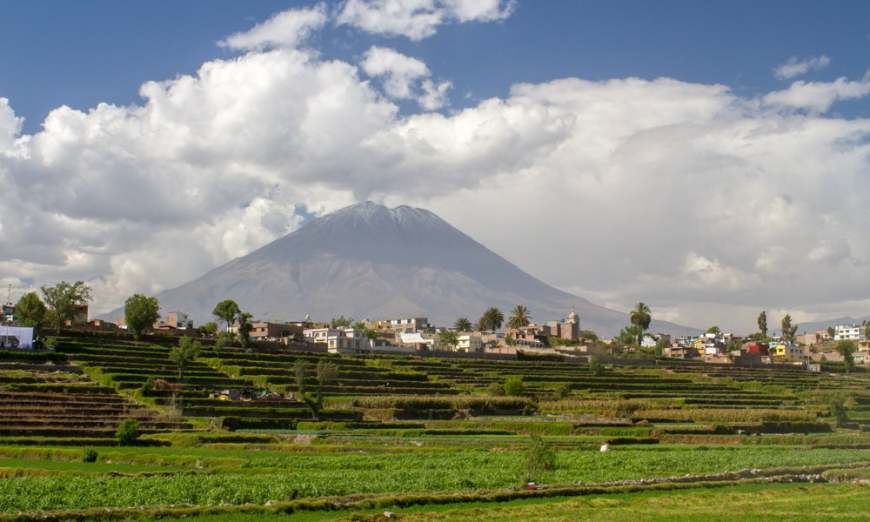 You don't see sights like this in the middle of most cities... Peru Group Tour Image: Arequipa from a distance, with a mountain in the background.