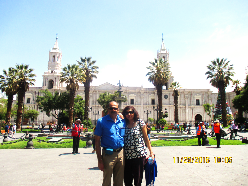 Make memories and tell stories — together. Peru Group Tour Image: Mr. and Mrs. Nayak pose in front of a cathedral.