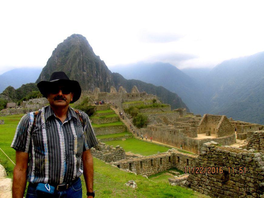 Photo at Machu Picchu? Yes, please! Peru Group Tour Image: Mr. Nayak stands in front of Machu Picchu.