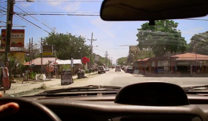 To truly make things easy, choose Anywhere's trusted and professional transport services. Is It Safe to Travel in Costa Rica Image: View of a town through a driver's windshield.