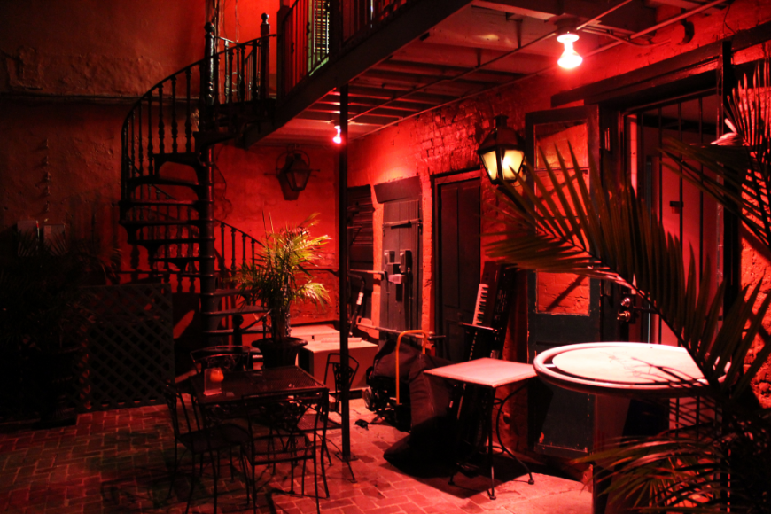 Make your 60th birthday sizzle... Salsa Dancing in Cuba: A sultry looking dance club with a spiral staircase is lit up red.