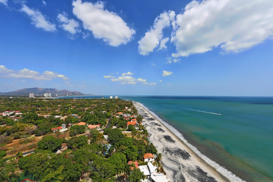 All of Panama is waiting for you. Summer In Panama Image: Partial aerial from a 23rd floor balcony showing both city and seashore.