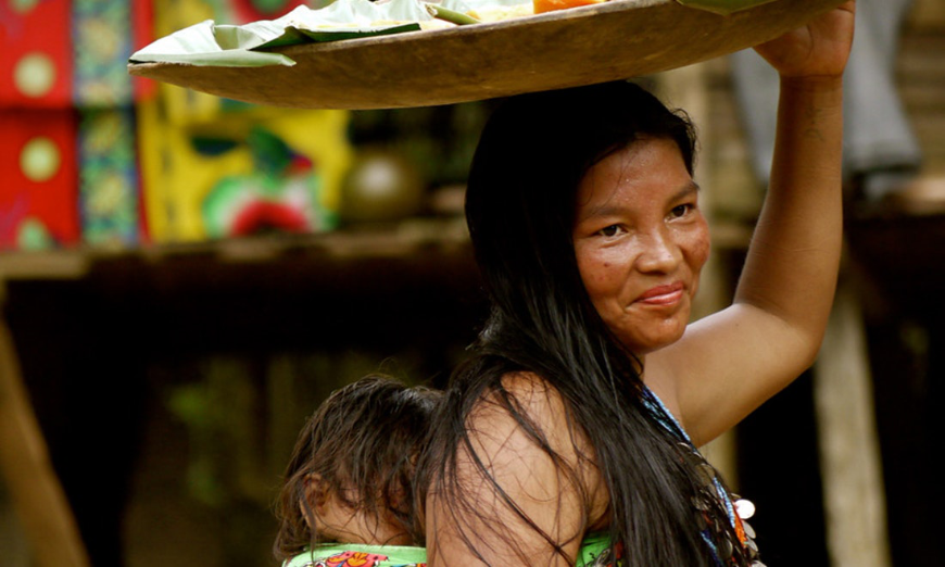 Remember that being welcomed into any part of an indigenous community is a privilege, and deserving of respect. Summer In Panama Image: A female member of the Emberà smiles whilst carrying a baby on her back and holding a platter on her head.