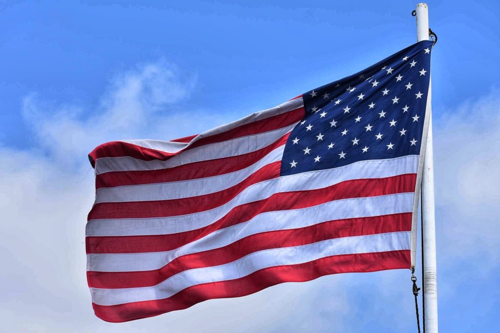 Why take unnecessary risks? Travel to Cuba legally. Legally Travel To Cuba Image: An American flag waves against the background of a cloud dappled blue sky.