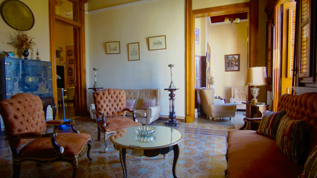 This room looks like a great place to sit down with your host, and get to know them over Cuban coffee. Legally Travel To Cuba Image: A salon/drawing room in the casa particular Hostal del Angel houses sofas, chairs, tables, and other furniture.