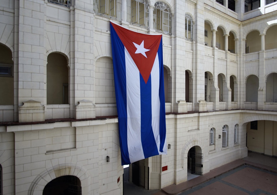 As you enjoy yourself, sip a Cuba Libre and reflect on what that STILL means in this country. Salsa Dancing in Cuba: A oversized Cuban flags hangs in the central square of a building.