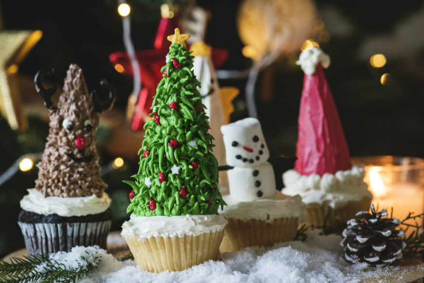 What tasty holiday décor. Tropical Holiday Image: Cupcakes decorated as a reindeer, Christmas tree, snow man, and Santa hat.