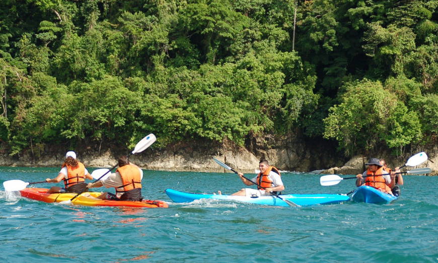 Kayaking is just one of many exciting adventures Anywhere offers. Why Choose A Travel Agent Image: Five people enjoy kayaking.