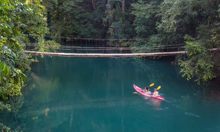 With traveler's insurance you can enjoy your holiday instead of fearing adventure. Why Travel Insurance Is A Must Image: Two people enjoy kayaking on vibrant water, surrounded by forest.