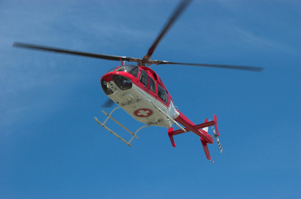 It's hard to tally figures when you're in and out of consciousness—buy travel insurance, and don't worry about it. Why Travel Insurance Is A Must Image: Medical helicopter taking off.